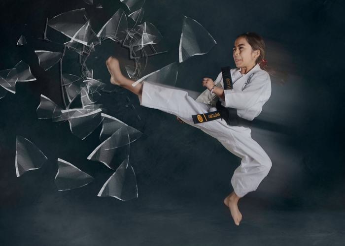 A girl flies through a jump kick